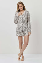 Woman wearing a patterned pajama set on a white background