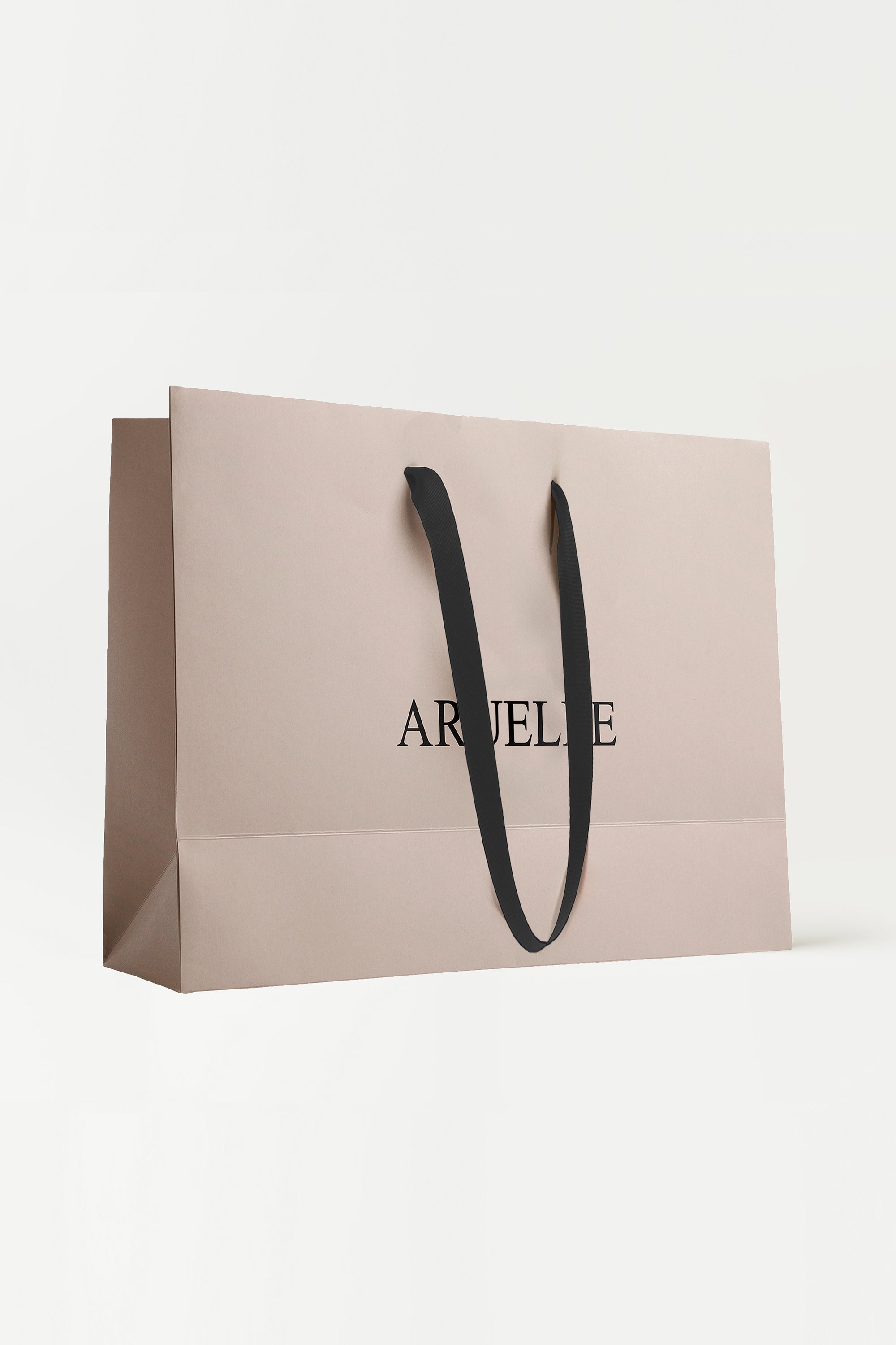 Beige shopping bag with black handle and 'ARUELLE' branding on a white background