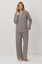 Woman wearing a striped pajama set on a white background