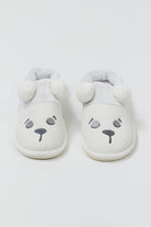 Pair of white slippers with bear face design on a light gray background