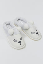 Pair of white slippers with bear face design on a light gray background