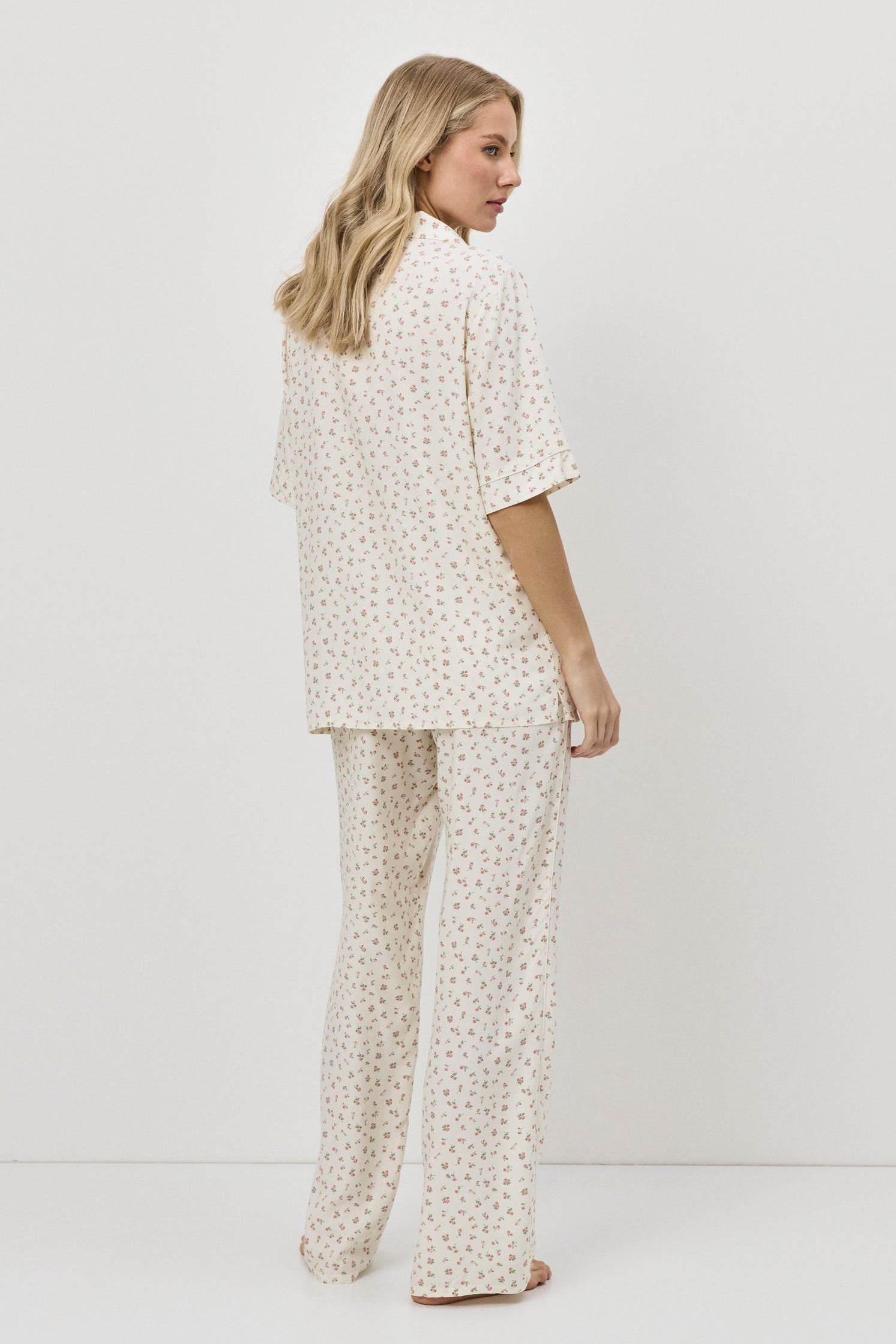 Woman wearing a pajama set against a white background