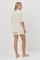 Woman wearing a pajama set on a white background