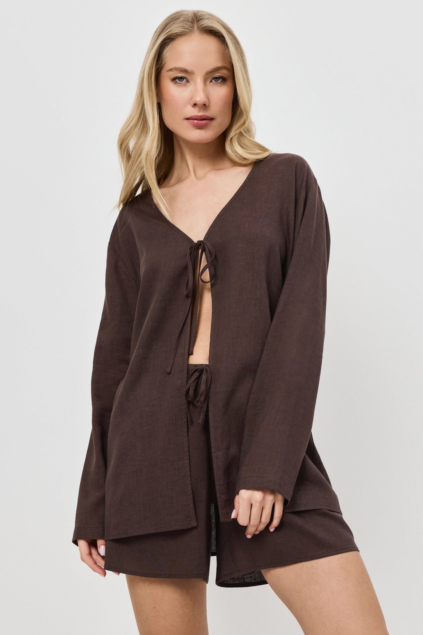 Woman wearing a brown resort wear set on a white background