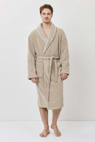 Man wearing a beige robe on a white background