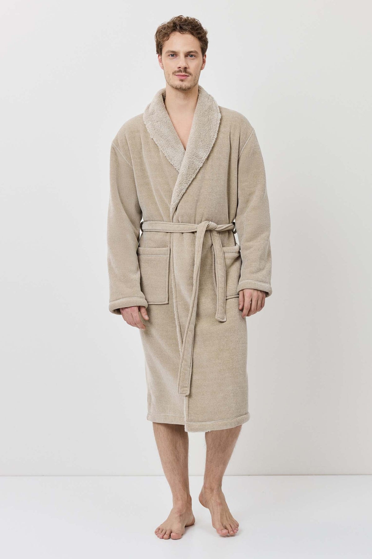 Man wearing a beige robe on a white background