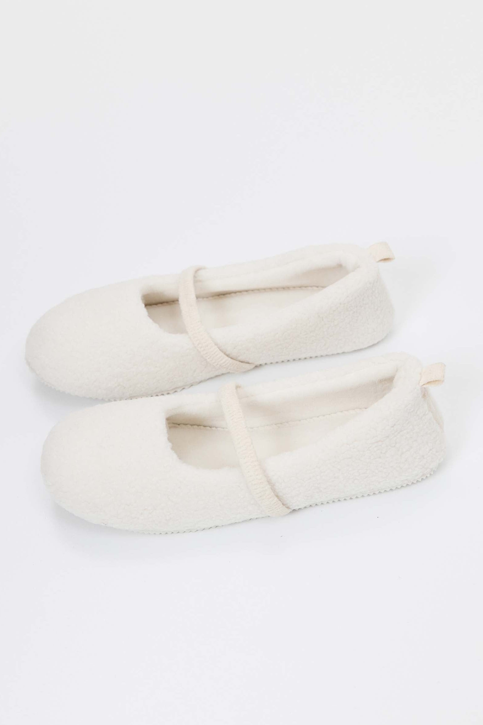Pair of white slippers on a white background