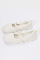 Pair of white slippers on a white background