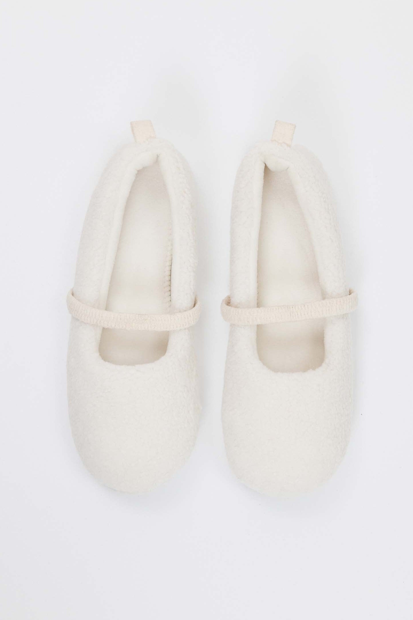 Pair of white loafers on a white background