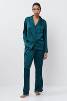 Woman wearing a pajama set on a white background