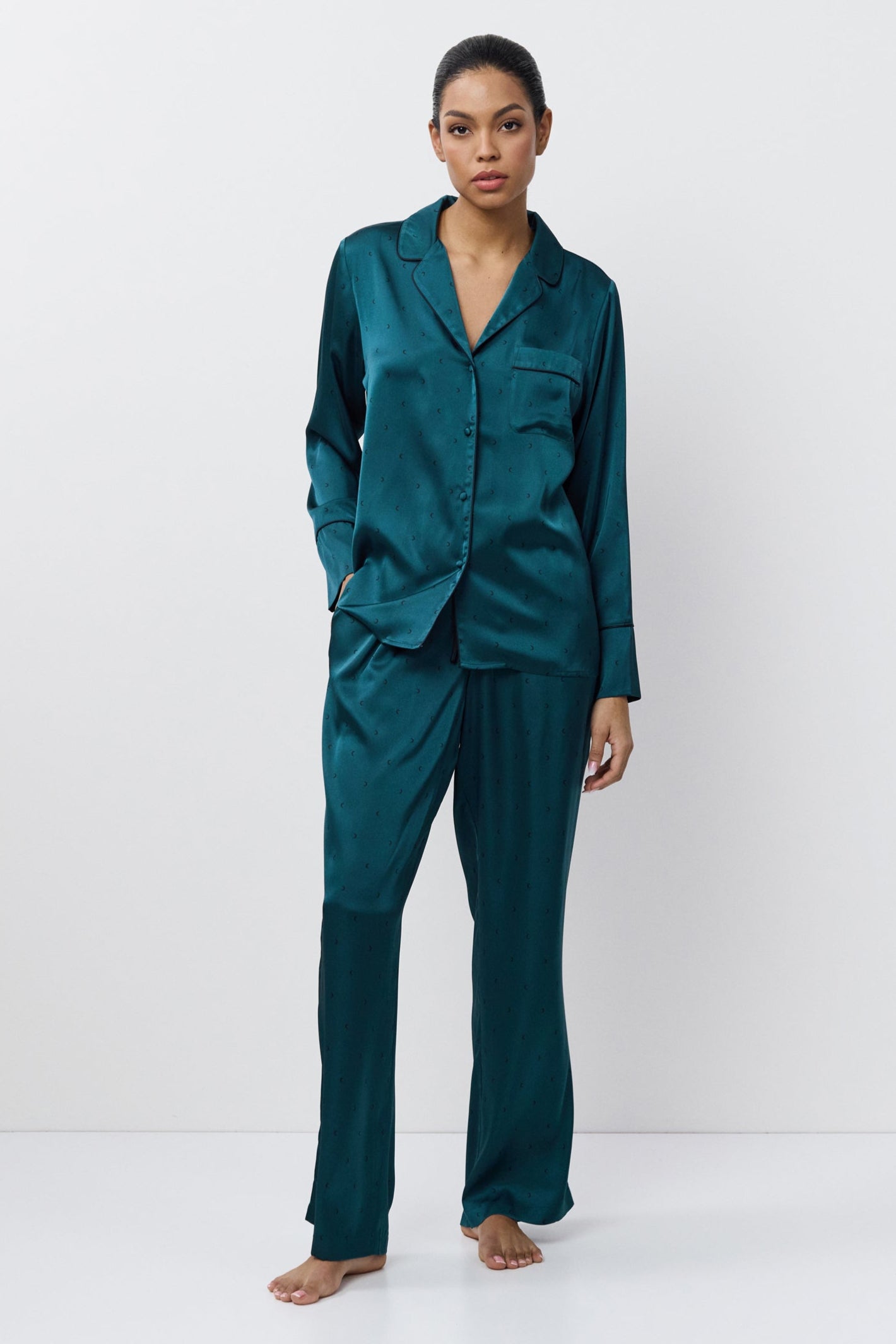 Woman wearing a pajama set on a white background