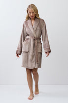 Woman wearing a choco bathrobe on a white background