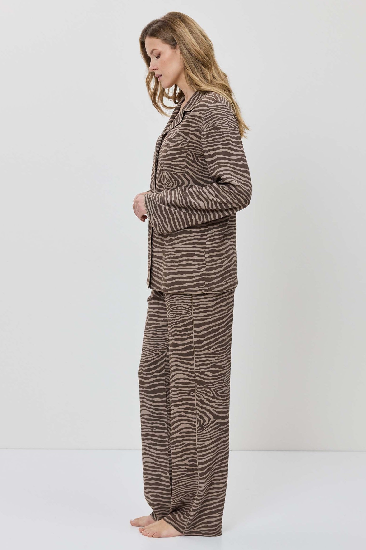 Woman wearing a zebra print outfit on a white background