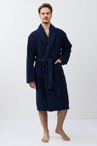 Man wearing a navy blue robe on a white background