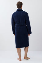 Man wearing a navy blue robe on a white background