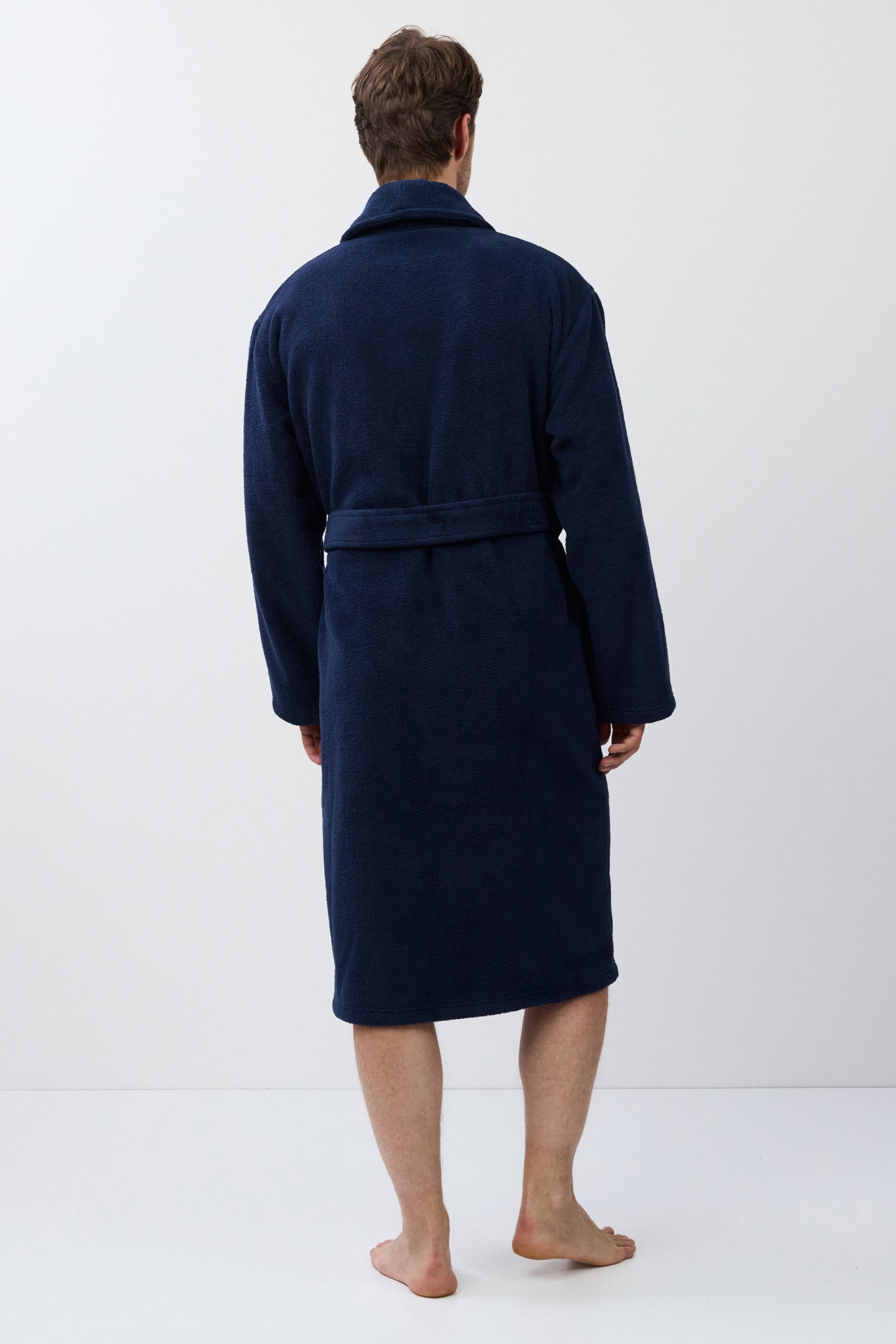 Man wearing a navy blue robe on a white background