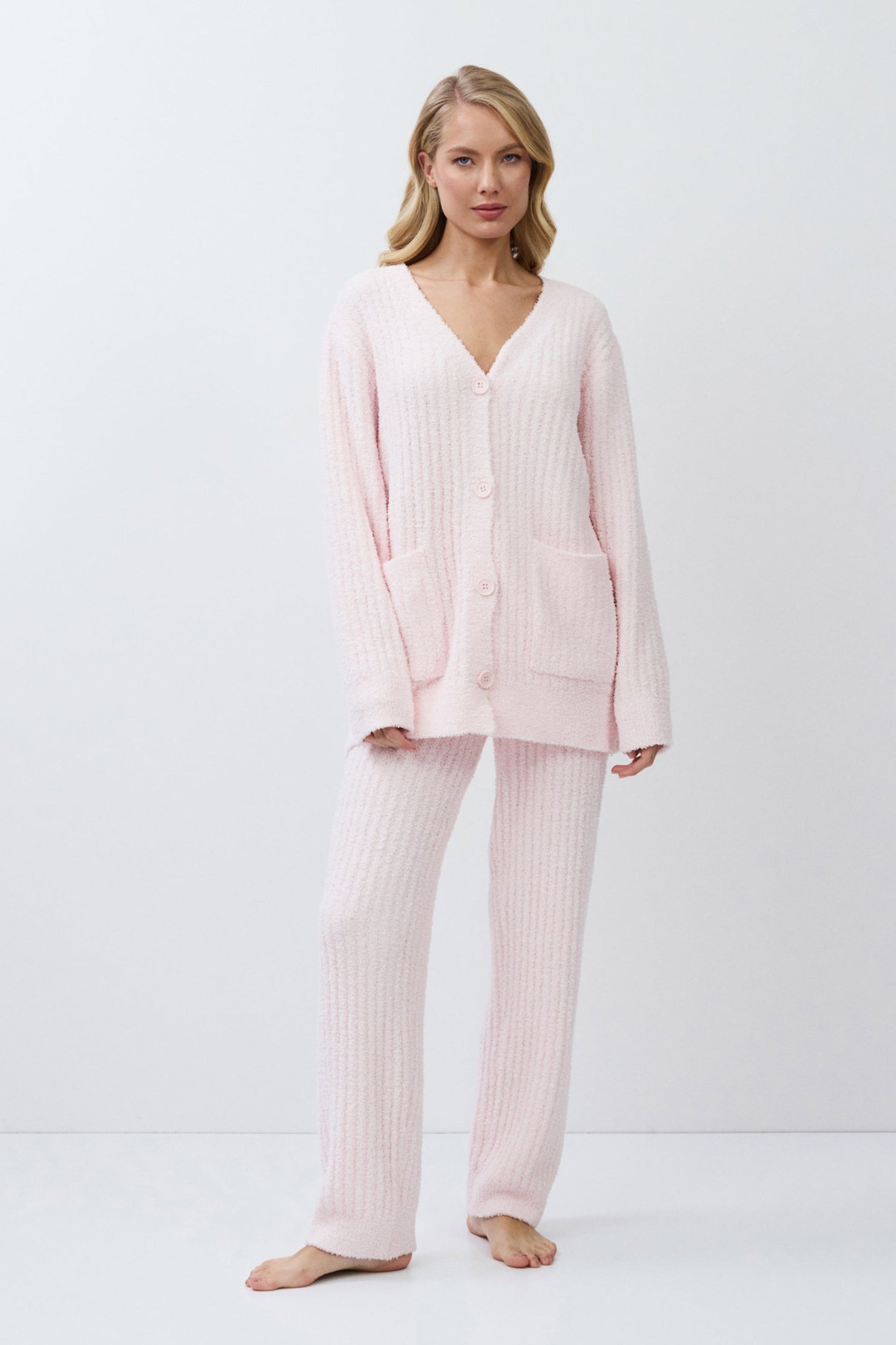 Woman wearing a pink set on a white background