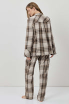 Person wearing a plaid outfit on a white background