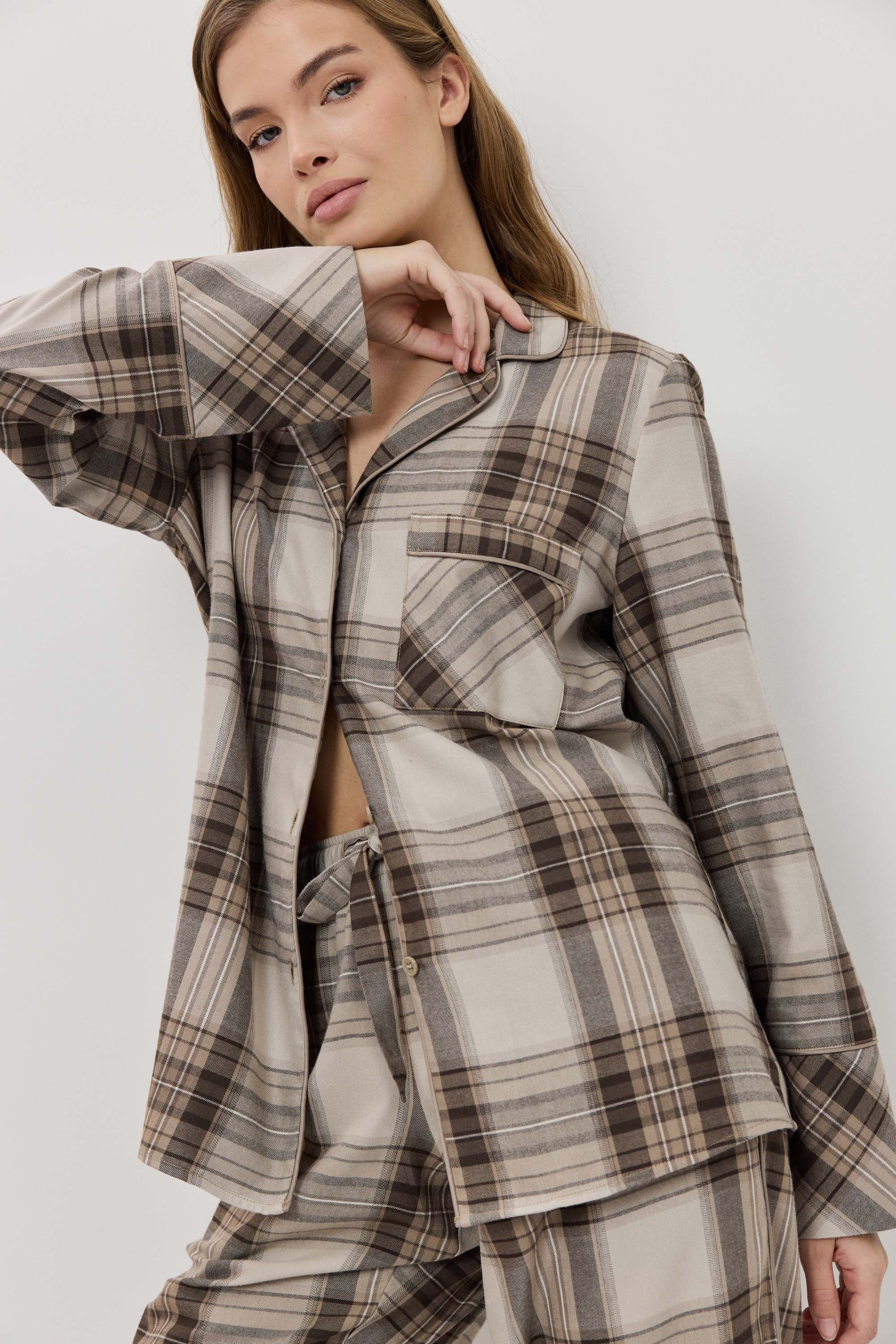 Woman wearing a plaid outfit on a white background