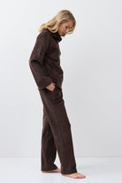 Person wearing a brown set against a white background