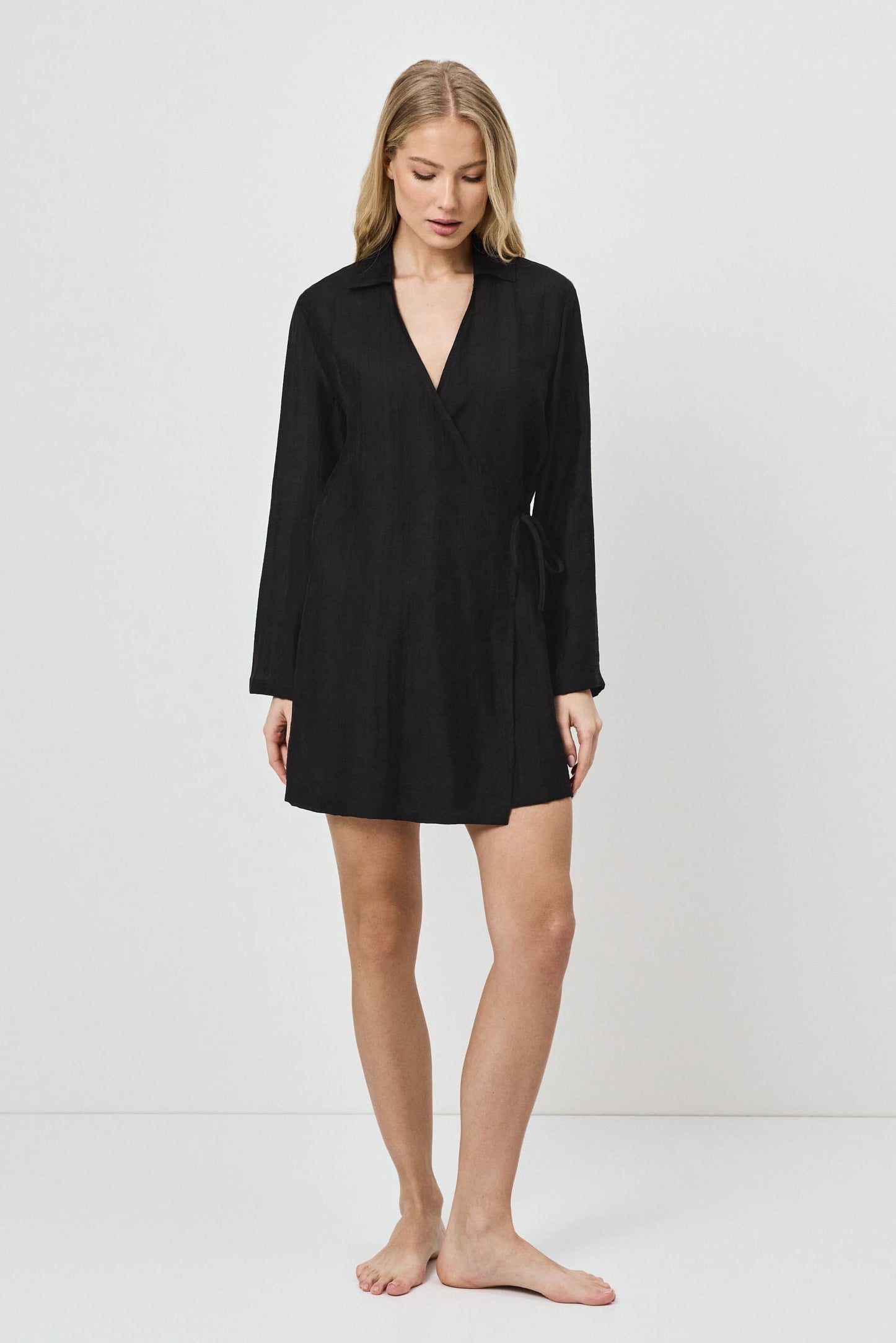 Woman wearing a black dress against a white background