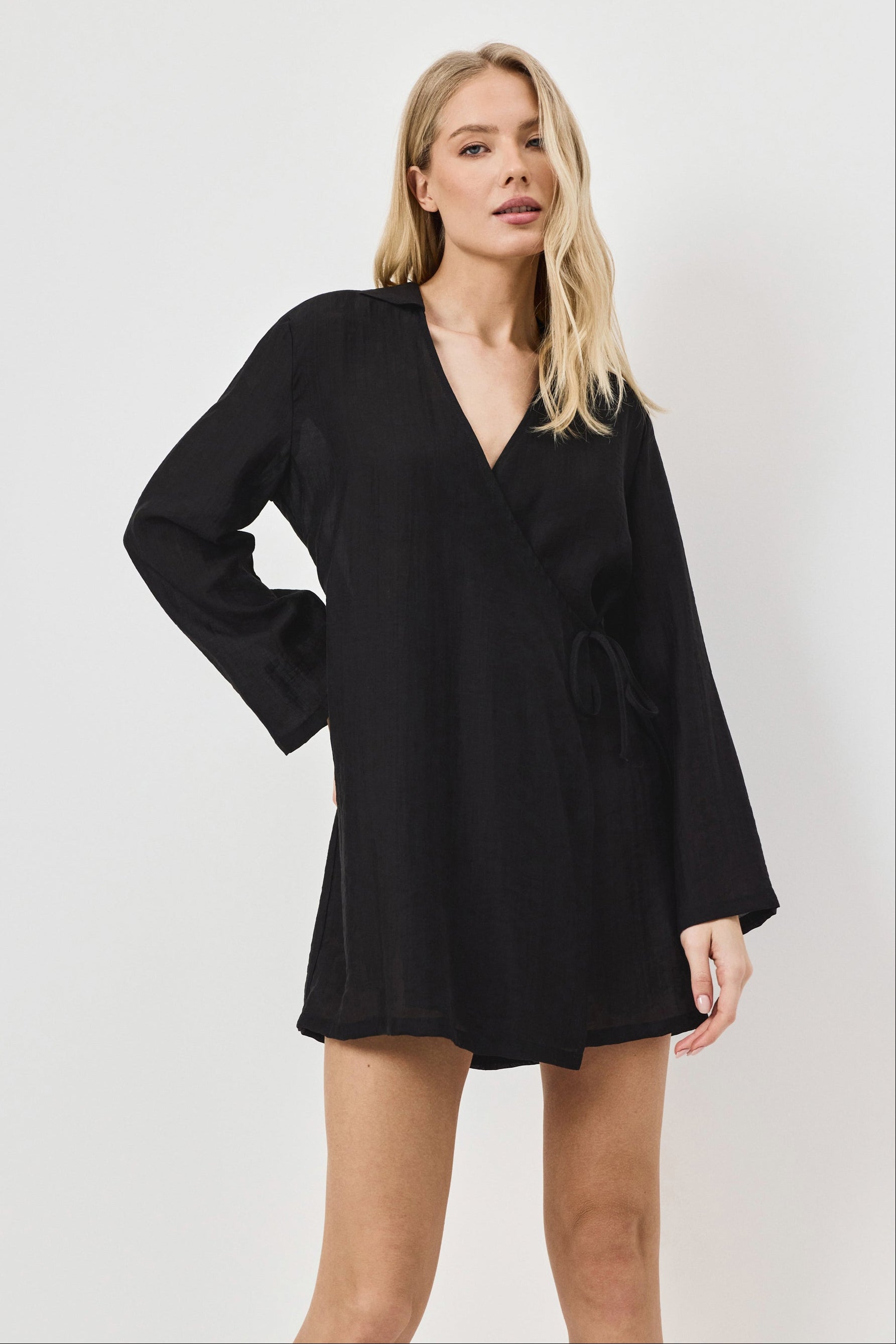 Woman wearing a black dress against a white background