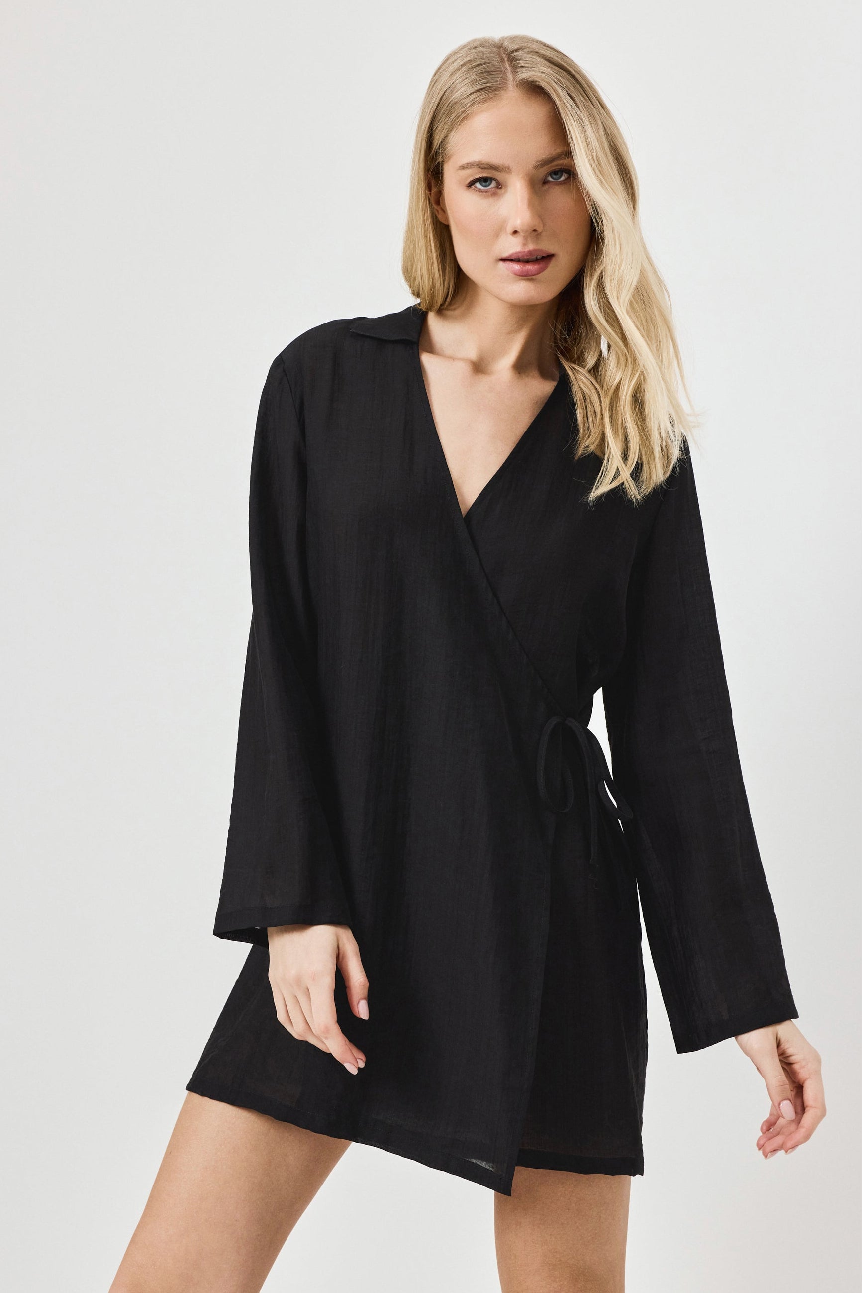 Woman wearing a black dress against a white background