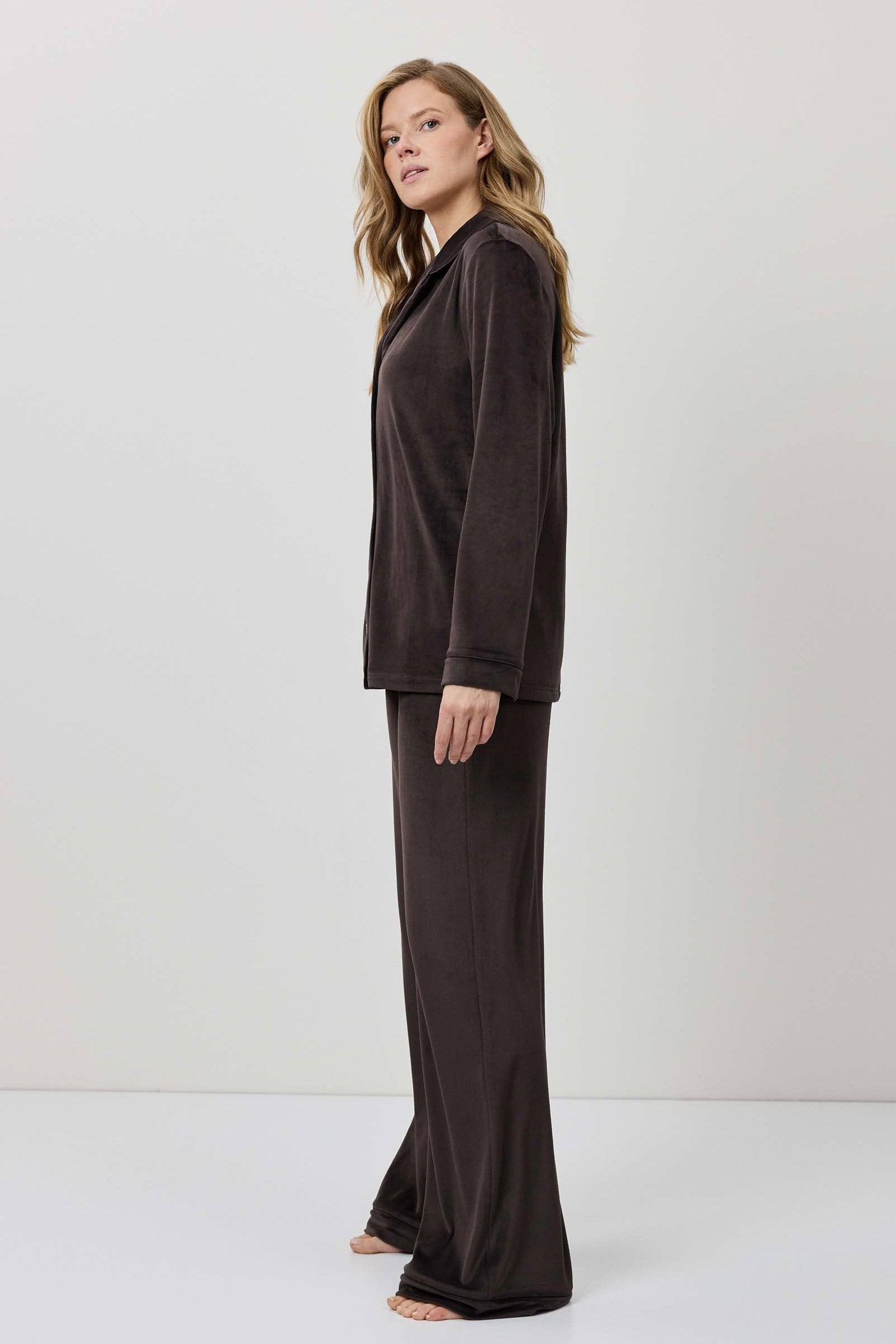 Woman wearing a brown outfit against a white background