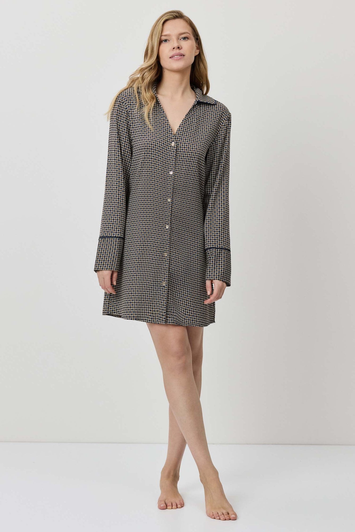 Woman wearing a checkered shirt dress on a white background