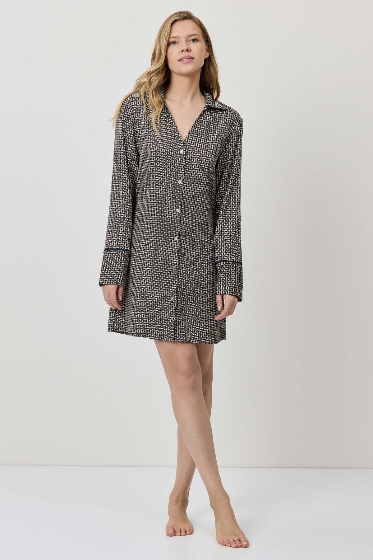 Woman wearing a checkered shirt dress on a white background