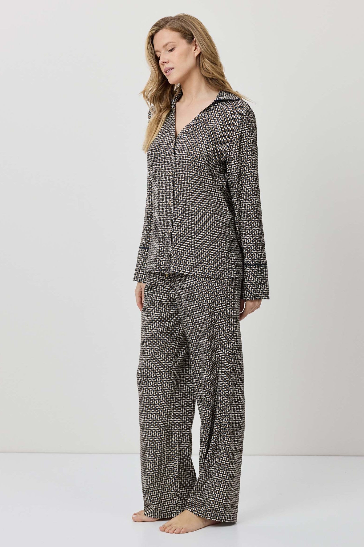 Woman wearing a checkered pajama set on a white background