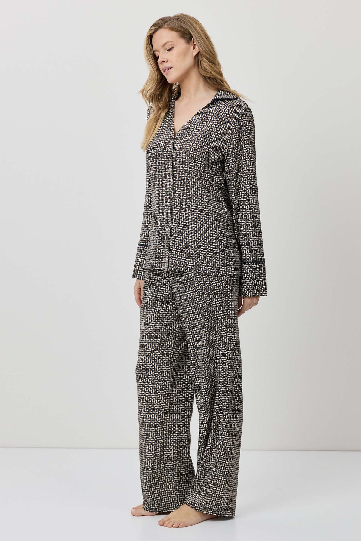 Woman wearing a checkered pajama set on a white background