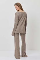 Woman wearing a brown outfit on a white background