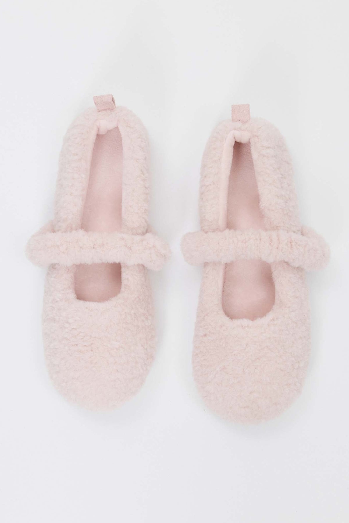 Pair of pink fuzzy slippers on a white background