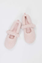 Pair of pink fuzzy slippers on a white background