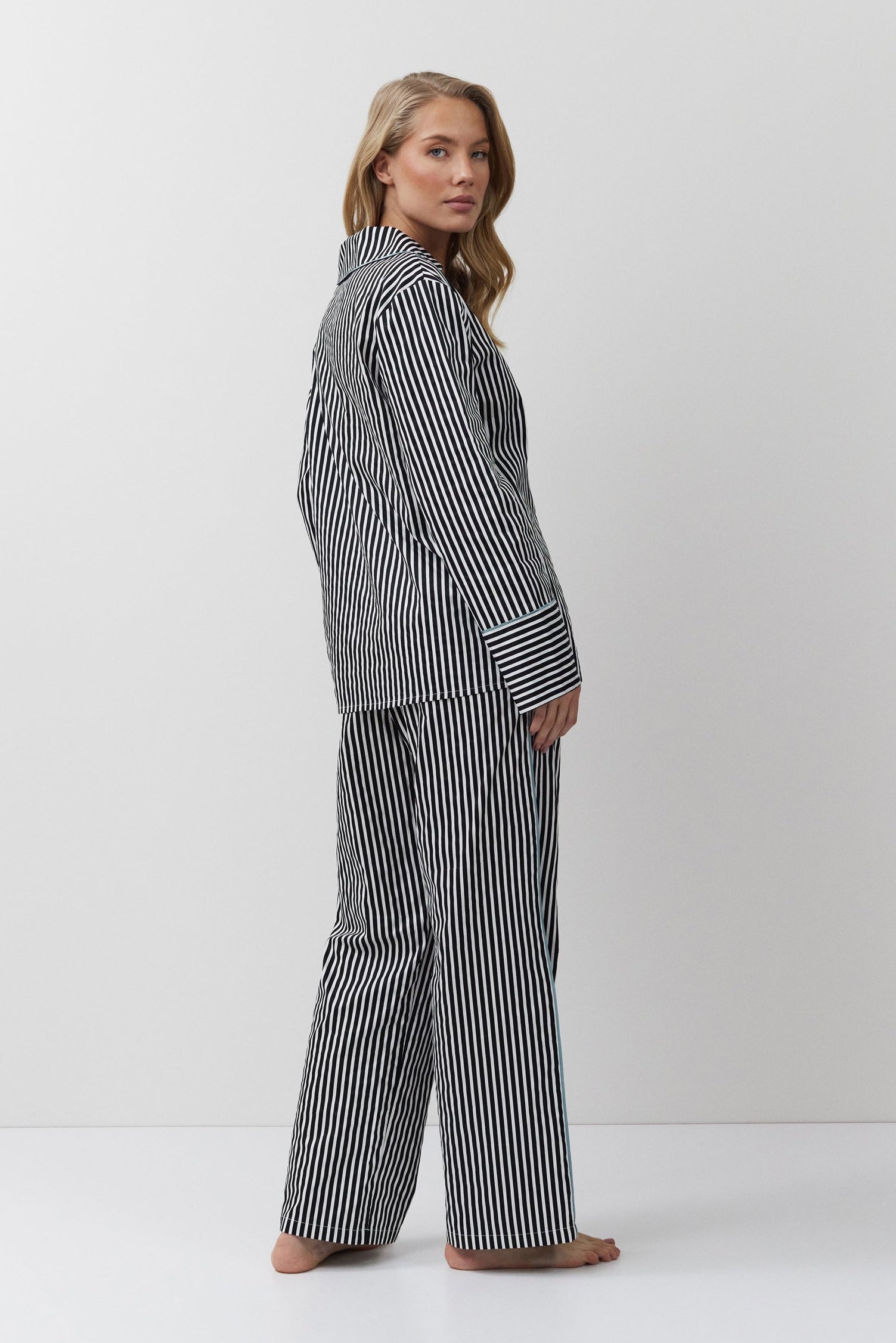Woman wearing a black and white striped outfit on a white background
