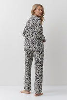 Woman wearing a black and white patterned onesie on a white background