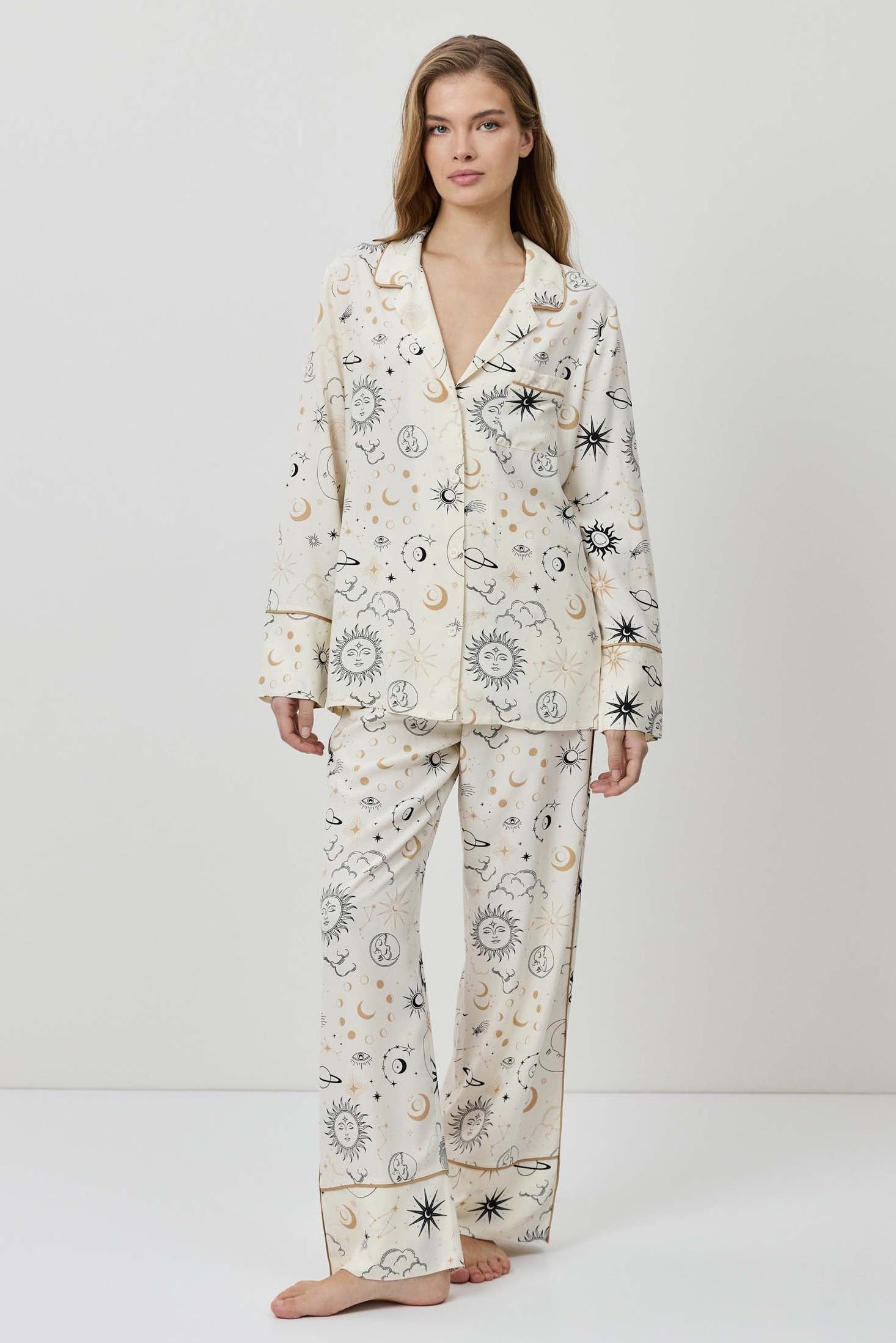 Woman wearing a floral pajama set on a white background