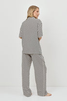 Woman wearing a pajama set on a white background